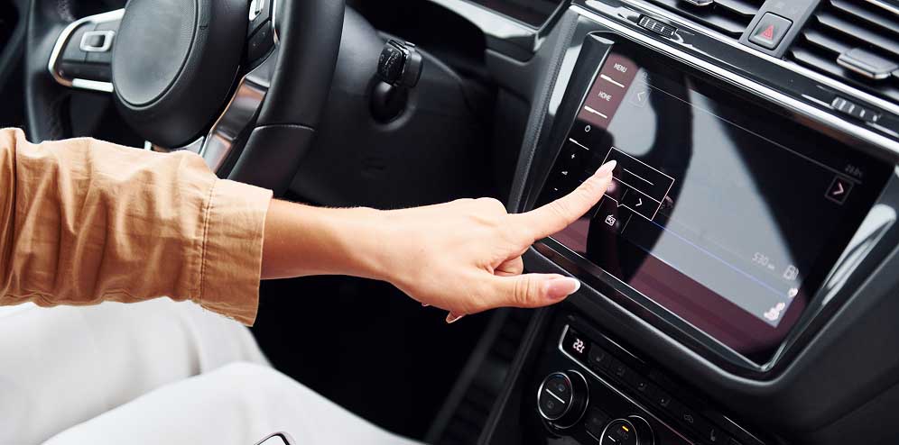Hand interacting with a car infotainment touchscreen
