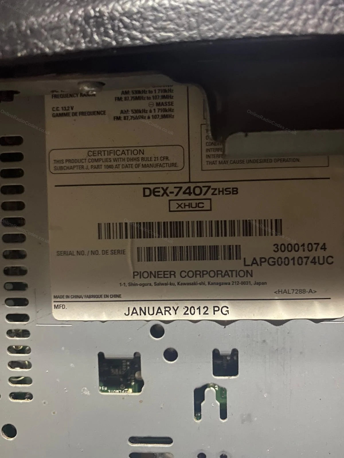 White serial number label on the casing of a Honda CD tuner